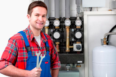 Licensed gas heating technician servicing a home heating system in Ottawa