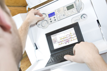 Licensed gas heating technician servicing a home heating system in Ottawa